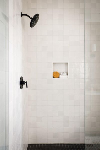 Floor to ceiling handmade tiles adorn the shower, elevating the pace to have a spa-like feel. Floor to ceiling handmade tiles adorn the shower, elevating the pace to have a spa-like feel.