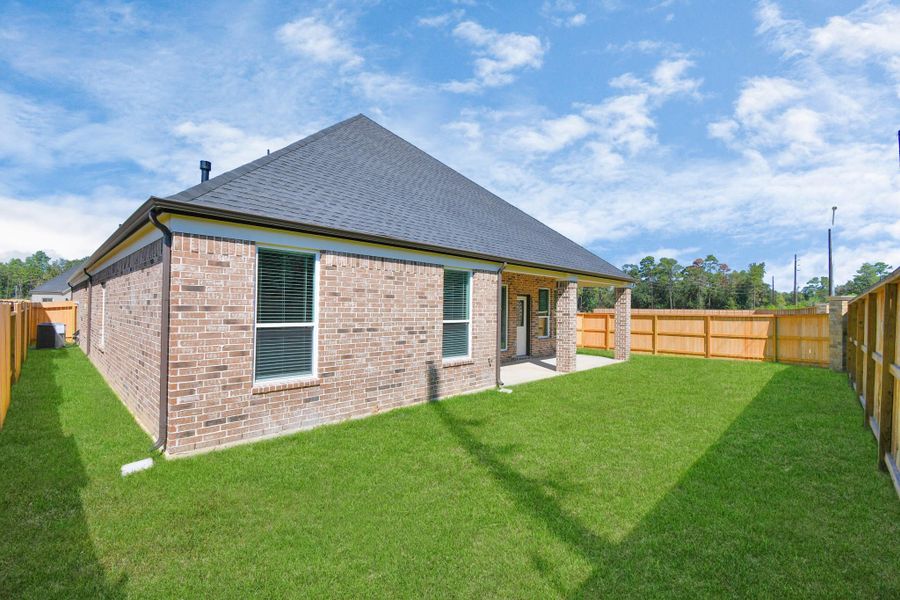 Backyard retreat, offering an abundance of space for kids to play and explore. The possibilities are endless in this outdoor haven, where the joy of open-air activities and family gatherings awaits. Sample photo of completed home with similar floor plan. Actual colors and selections may vary. Backyard retreat, offering an abundance of space for kids to play and explore. The possibilities are endless in this outdoor haven, where the joy of open-air activities and family gatherings awaits. Sample photo of completed home with similar floor plan. Actual colors and selections may vary.