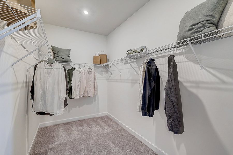 A room with a white wall and a white wall with a white cloth and a white towel rack.