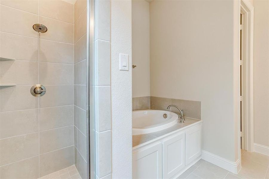 Bathroom with plus walk in shower and tile patterned floors