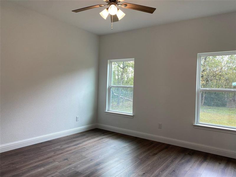Bedroom with dark wood finished floors and ceiling fan Bedroom with dark wood finished floors and ceiling fan