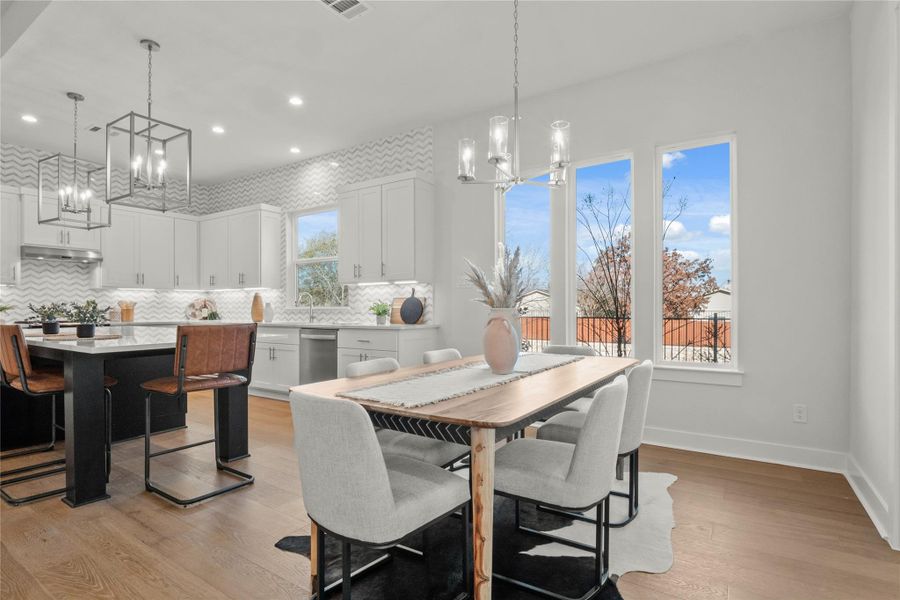 Dining area featuring a chandelier, light wood-style floors, and recessed lighting Dining area featuring a chandelier, light wood-style floors, and recessed lighting