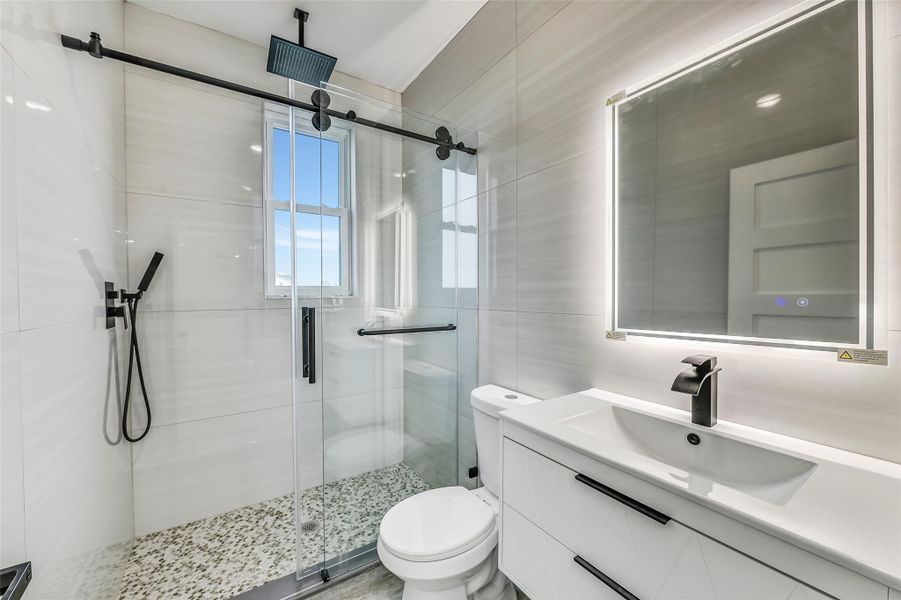 Clean lines give this secondary bath a fresh and modern feel. The glass enclosed shower and streamlined fixtures offer guests privacy, comfort, and polished style. Its convenient placement supports both family living and overnight visitors. Clean lines give this secondary bath a fresh and modern feel. The glass enclosed shower and streamlined fixtures offer guests privacy, comfort, and polished style. Its convenient placement supports both family living and overnight visitors.