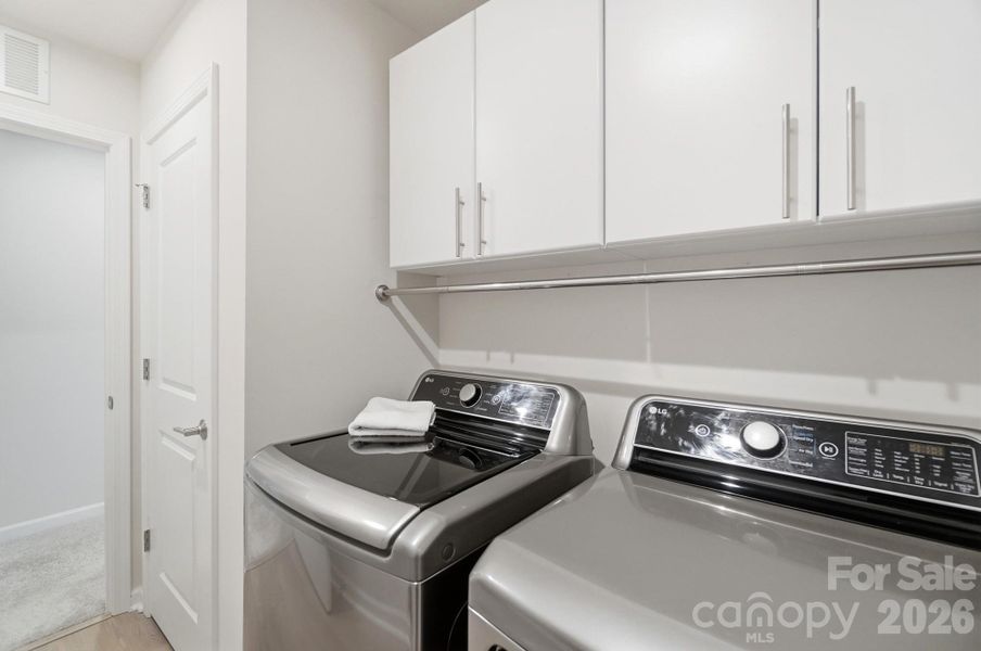 Owners added laundry cabinets for added storage and organization!
