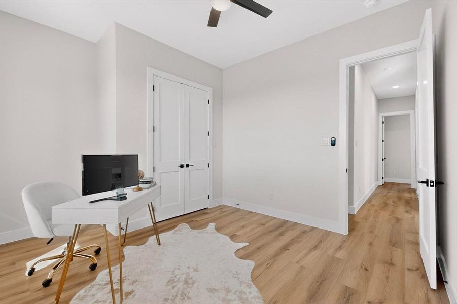Office area featuring light wood finished floors and ceiling fan