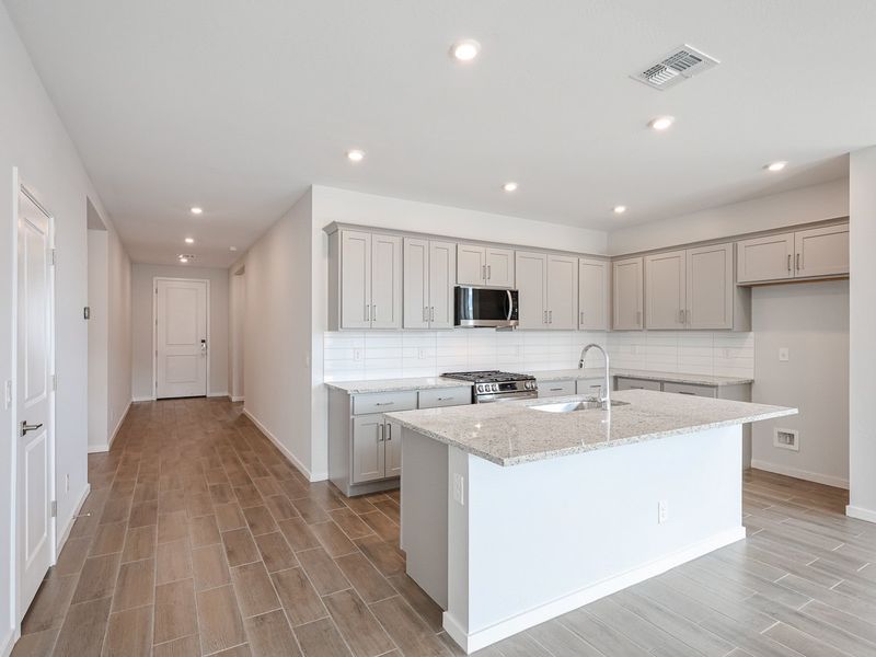 A kitchen with white cabinets.