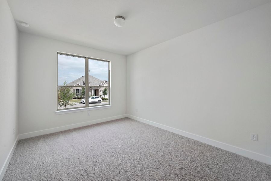 Spare room with baseboards and light colored carpet