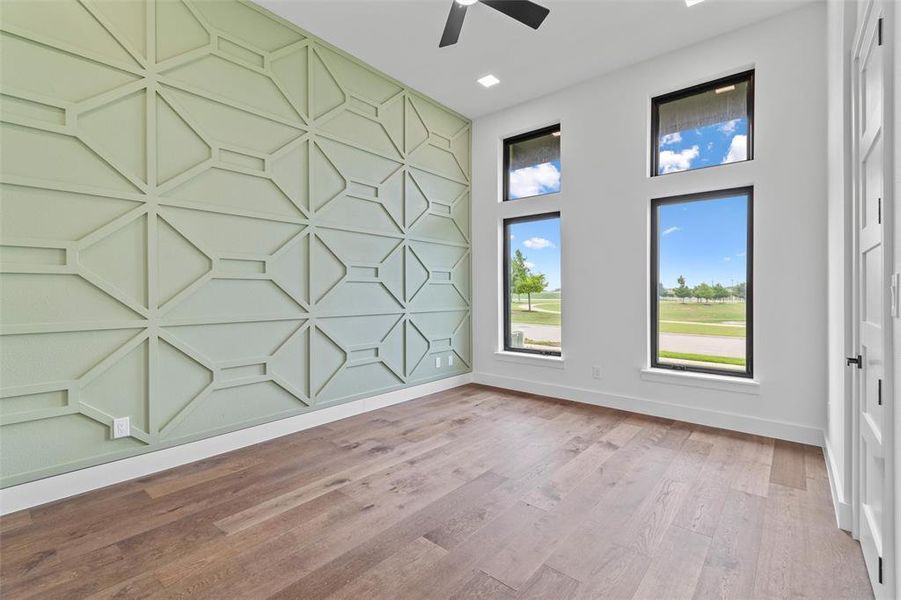 Spare room featuring ceiling fan and hardwood / wood-style flooring