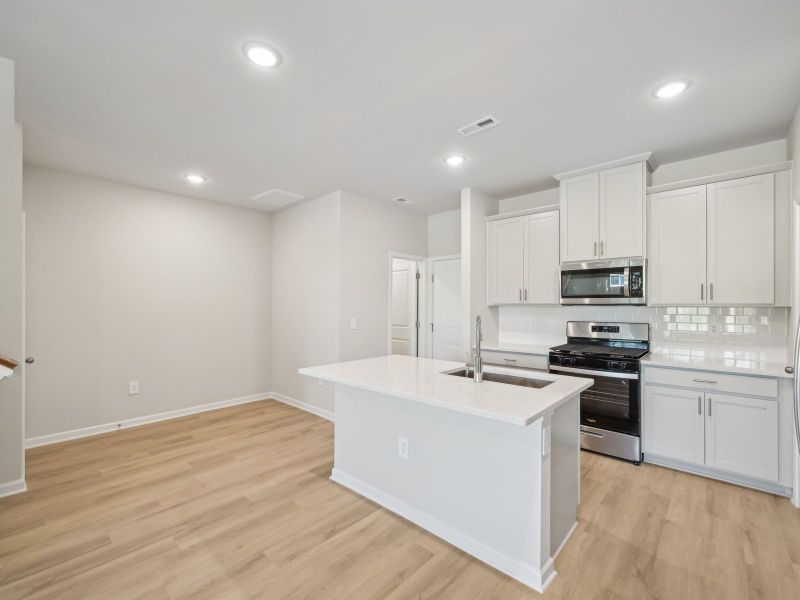 The spacious kitchen island is at the heart of the open-concept first floor.