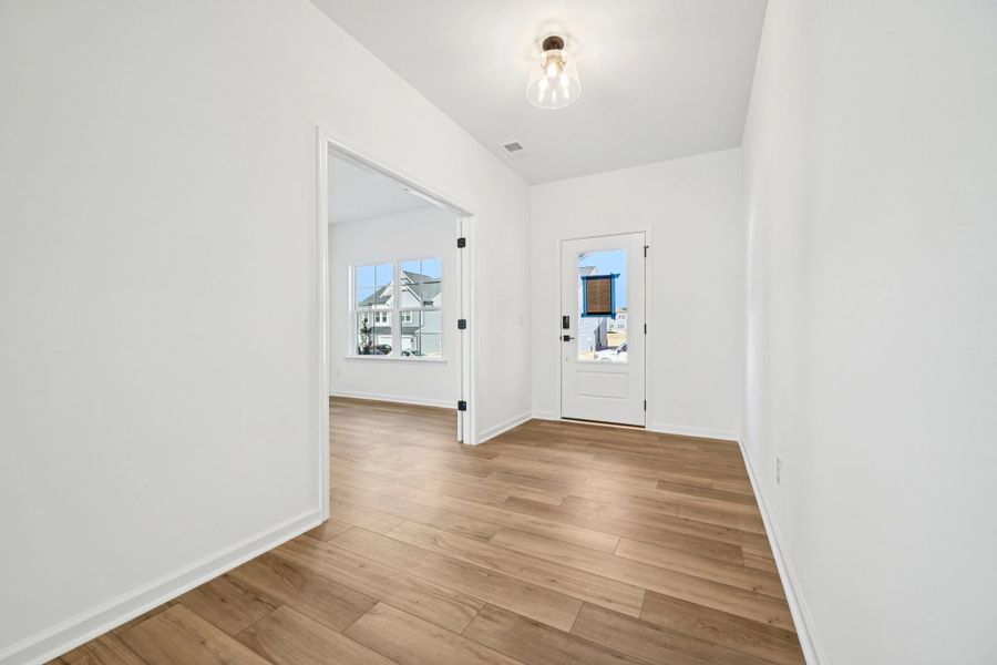 Foyer featuring the AW Collection® Rosemary - Natural light and bold color create grounded warmth.