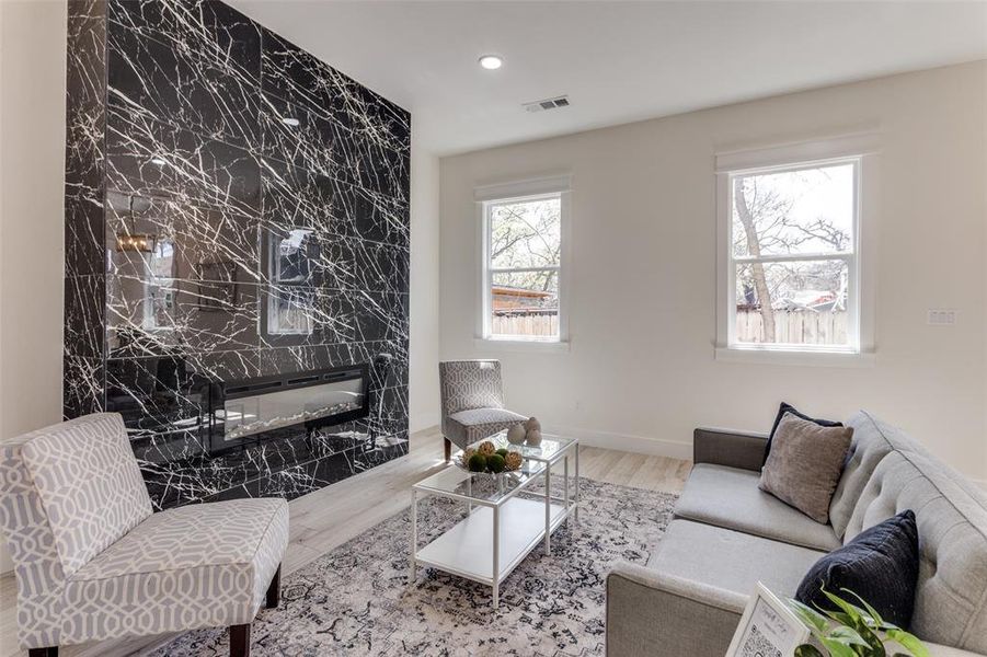 Living area featuring visible vents, recessed lighting, baseboards, and wood finished floors