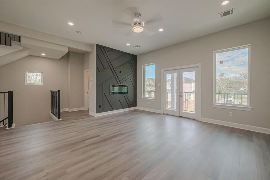 Unit 2: Bright living room with double doors to front facing balcony.