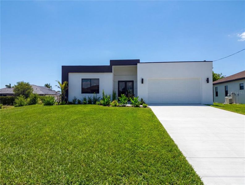 Front exterior of a new home in , Cape Coral, FL, highlighting curb appeal (Image 28). Front exterior of a new home in , Cape Coral, FL, highlighting curb appeal (Image 28).