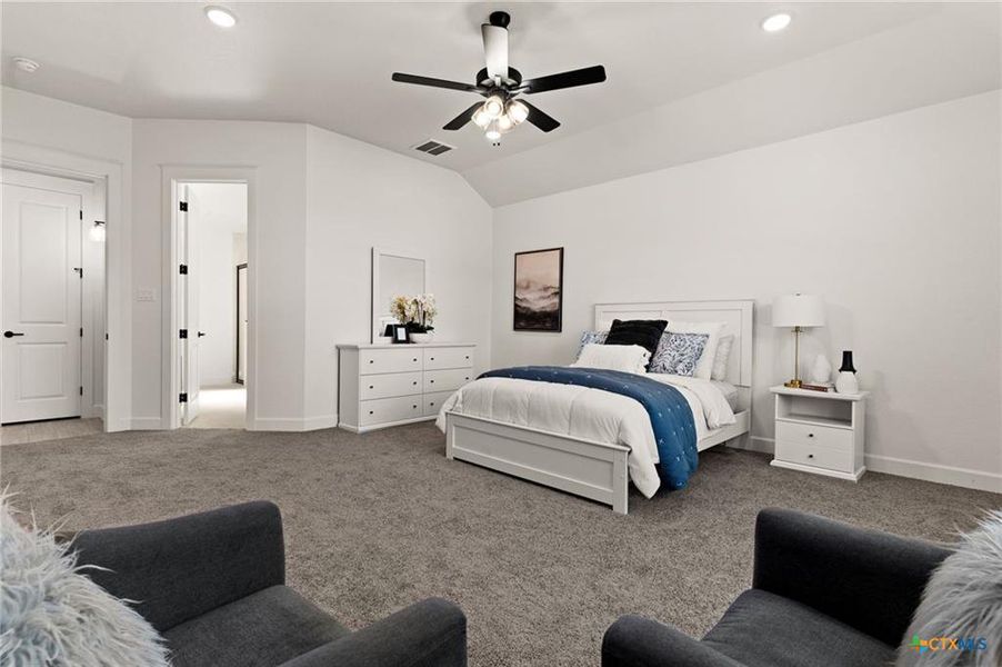 Carpeted bedroom featuring lofted ceiling, ceiling fan, and recessed lighting
