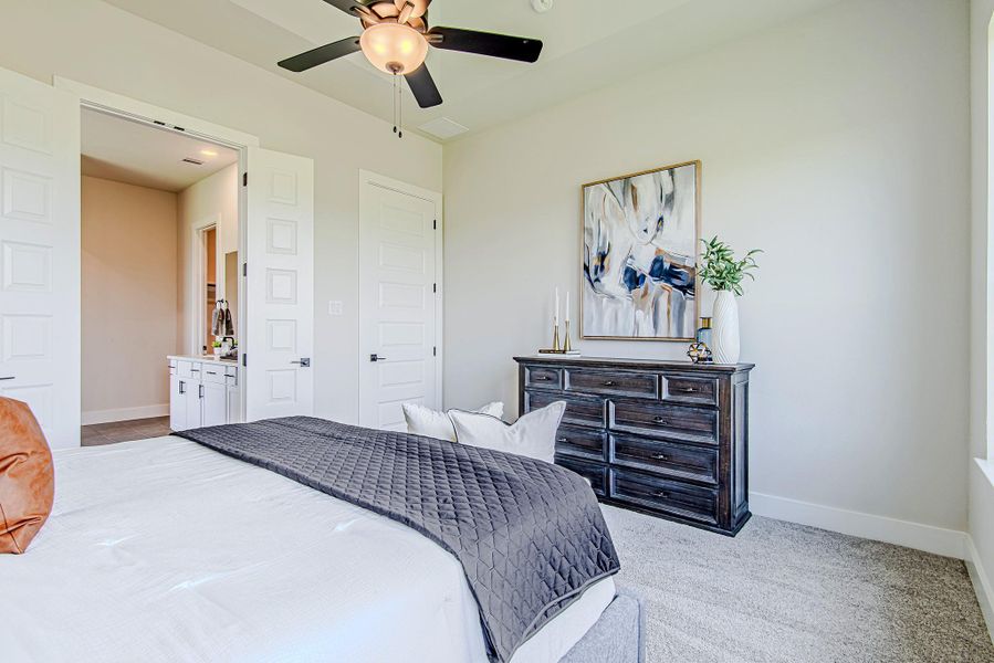 Spacious and stylish, the primary suite offers plenty of room for furniture placement and includes access to a spa-like bath.