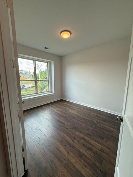 The study features a bench seat at the window with french doors.
