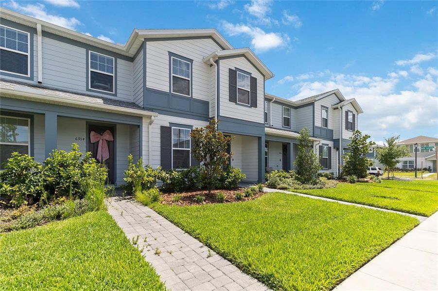 Front exterior of a new home in , Orlando, FL, highlighting curb appeal (Image 26). Front exterior of a new home in , Orlando, FL, highlighting curb appeal (Image 26).