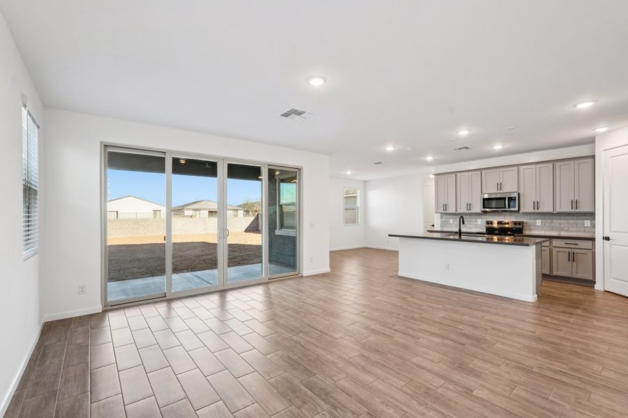 Great room, kitchen and dining. Finishes and options may vary.