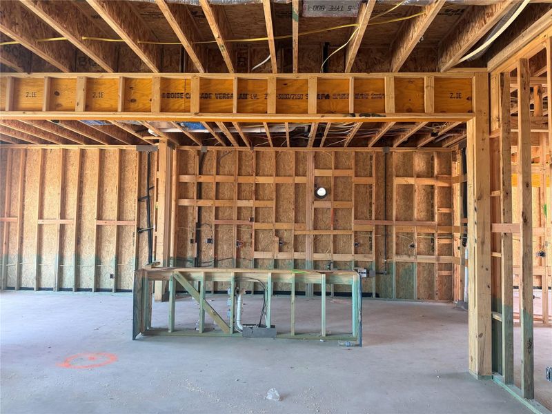 Exposed wood framing and concrete flooring outline the spacious layout of this under-construction residence.