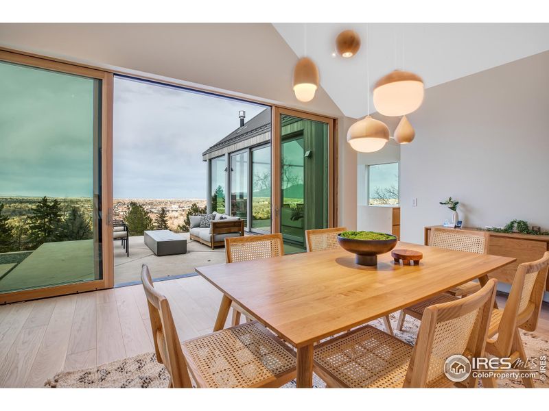 Dining room overlooking heated patio / firepit / city views