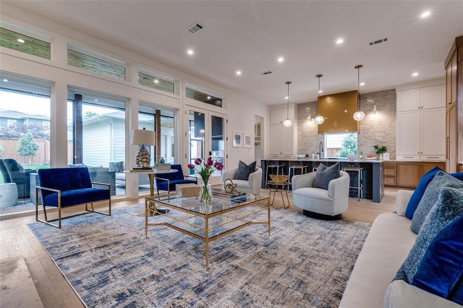 Living room featuring recessed lighting, light wood-style flooring, and visible vents Living room featuring recessed lighting, light wood-style flooring, and visible vents