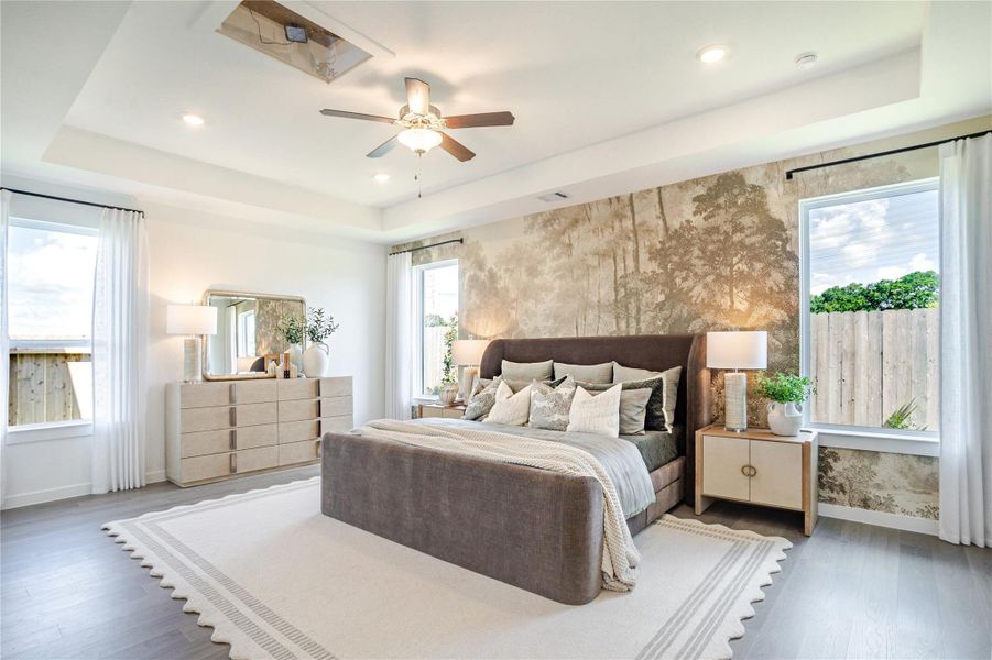This spacious bedroom features a modern design with a statement wall, large windows for natural light, and elegant furnishings including a plush bed and sleek dresser. The room is complemented by a ceiling fan and recessed lighting for added comfort and style. This spacious bedroom features a modern design with a statement wall, large windows for natural light, and elegant furnishings including a plush bed and sleek dresser. The room is complemented by a ceiling fan and recessed lighting for added comfort and style.