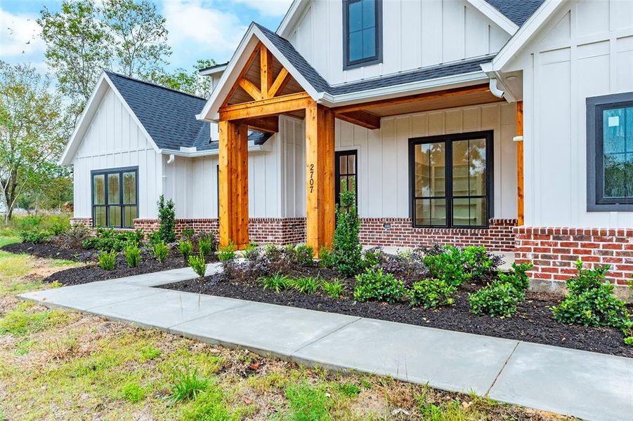 Fron porch with lush landscape