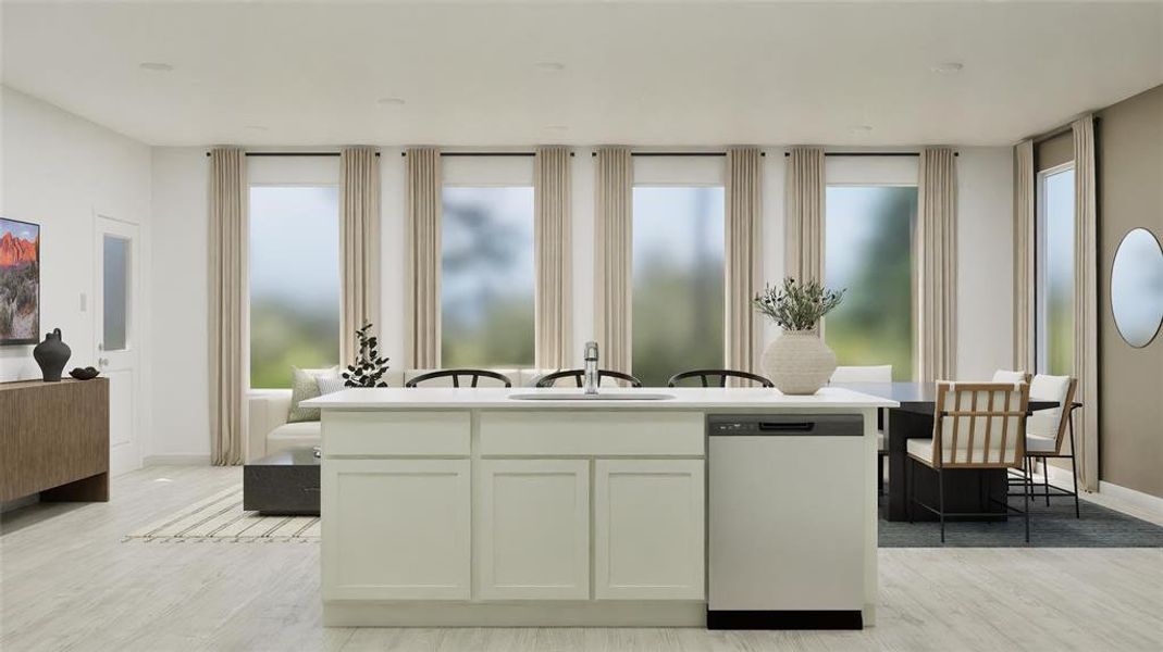 Kitchen with dishwashing machine, a kitchen island with sink, white cabinetry, and light wood-style flooring
