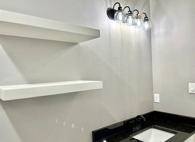 Bathroom with a textured wall and vanity Bathroom with a textured wall and vanity