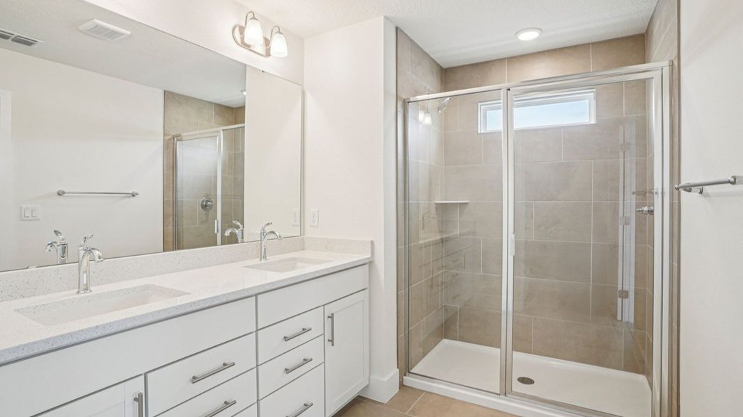 Dual vanity with quartz countertop in the Plumeria plan at Lakeside at Satilla by DRB Homes. Dual vanity with quartz countertop in the Plumeria plan at Lakeside at Satilla by DRB Homes.