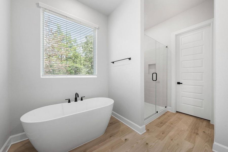 Master bathroom includes granite countertop, elongated mirror, and dual-vanity sinks. Relax in the large soaking tub or enjoy the spacious, standing shower.