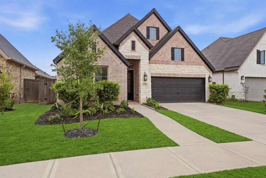 Front exterior of a new home in Riceland, Mont Belvieu, TX, highlighting curb appeal (Image 19). Front exterior of a new home in Riceland, Mont Belvieu, TX, highlighting curb appeal (Image 19).