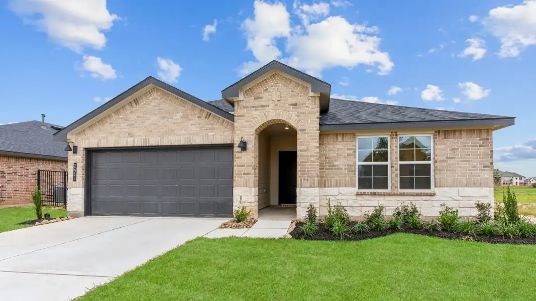 Front exterior of a new home in Lago Mar 60' Homesites, Texas City, TX, highlighting curb appeal (Image 2). Front exterior of a new home in Lago Mar 60' Homesites, Texas City, TX, highlighting curb appeal (Image 2).