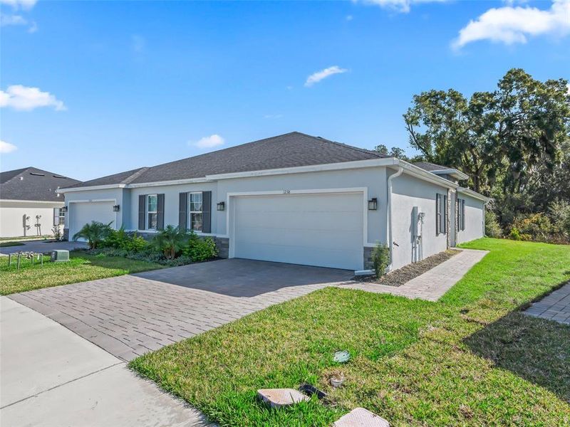Front exterior of a new home in , Lady Lake, FL, highlighting curb appeal (Image 26). Front exterior of a new home in , Lady Lake, FL, highlighting curb appeal (Image 26).