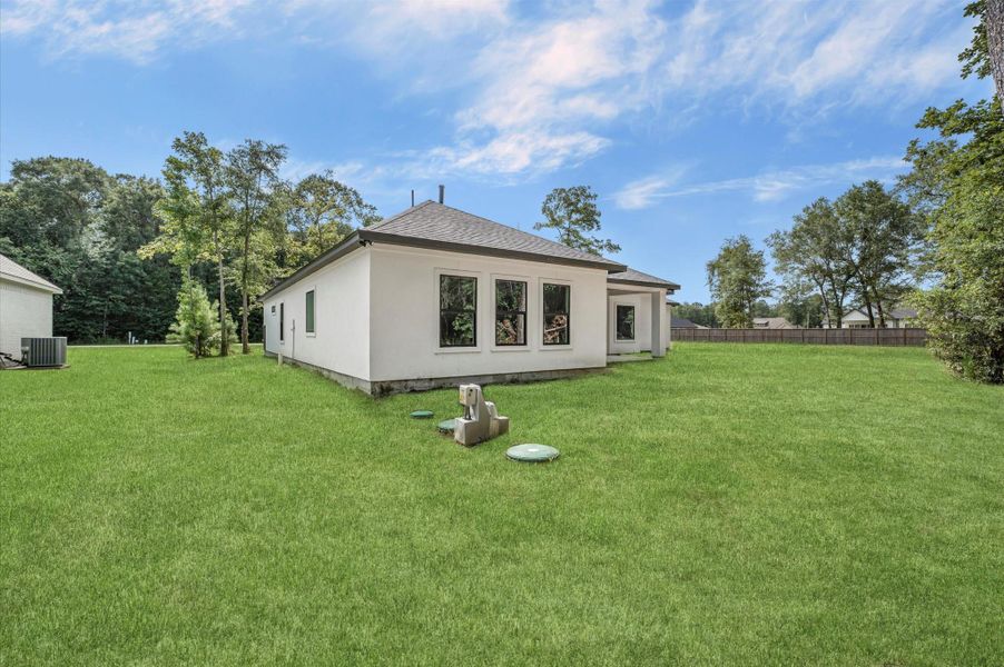 This photo shows a modern white house with a spacious, well-maintained lawn. It features large windows and is surrounded by mature trees, offering a peaceful and private setting. Perfect for those seeking a serene outdoor space. This photo shows a modern white house with a spacious, well-maintained lawn. It features large windows and is surrounded by mature trees, offering a peaceful and private setting. Perfect for those seeking a serene outdoor space.
