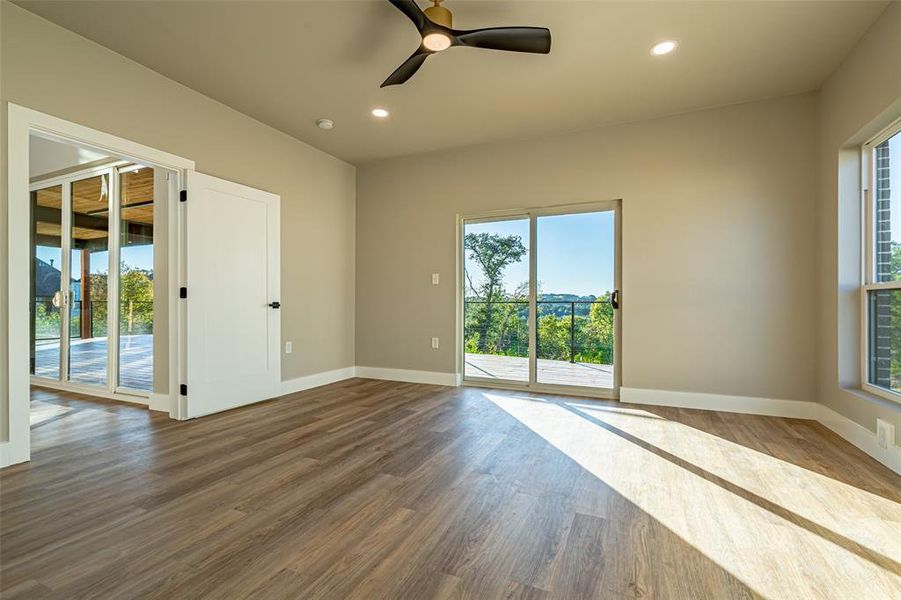 Spare room with plenty of natural light, recessed lighting, wood finished floors, and a ceiling fan Spare room with plenty of natural light, recessed lighting, wood finished floors, and a ceiling fan