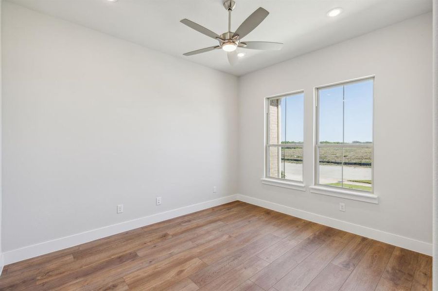 Empty room featuring light hardwood / wood-style floors and ceiling fan