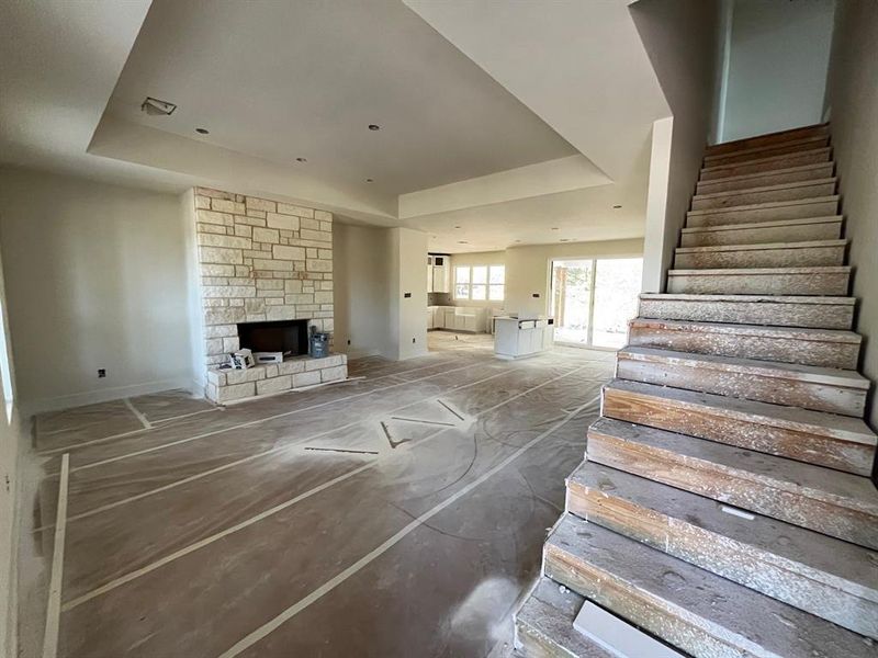 Living area with a raised ceiling and a fireplace