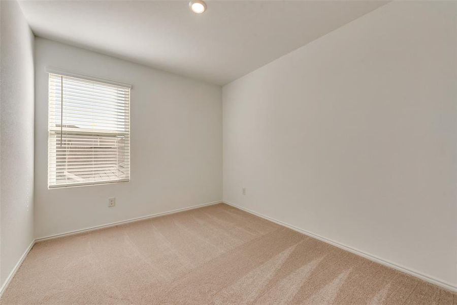 Empty room featuring light carpet