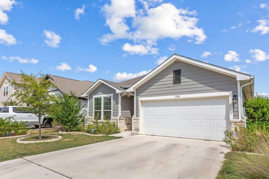 Front exterior of a new home in The Ridge at Trinity Ranch, Elgin, TX, highlighting curb appeal (Image 1). Front exterior of a new home in The Ridge at Trinity Ranch, Elgin, TX, highlighting curb appeal (Image 1).