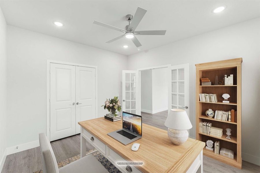 Home office with wood desk, ceiling fan, bookshelf, and French doors leading to adjacent room