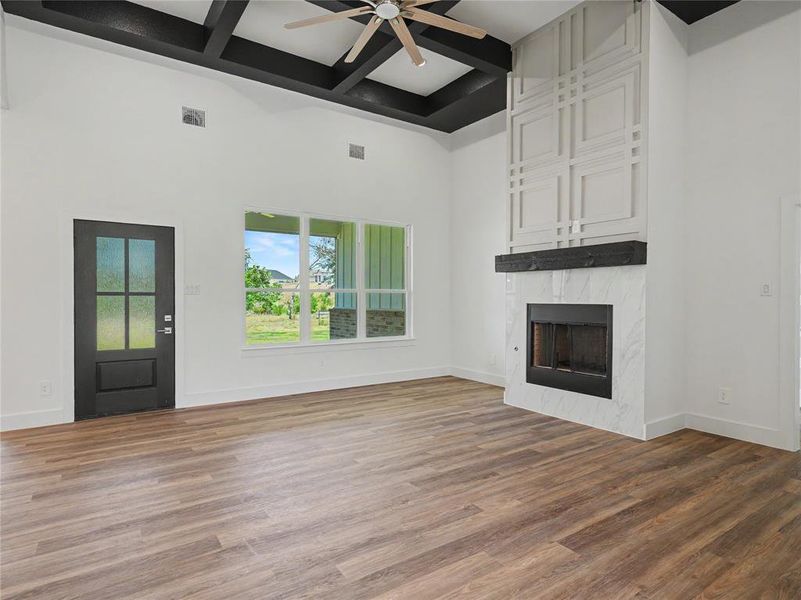 Vaulted ceiling with dark-stained exposed beams and a ceiling fan