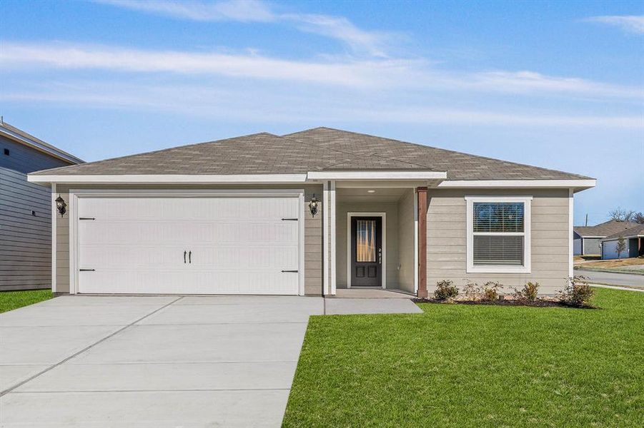 Single story home with a garage and a front lawn