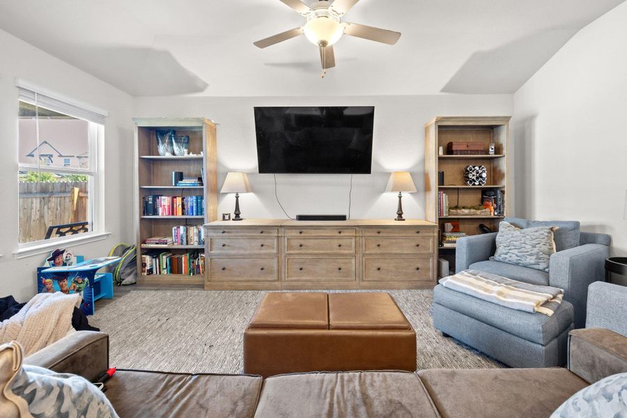 Living room featuring a ceiling fan and wood finished floors Living room featuring a ceiling fan and wood finished floors