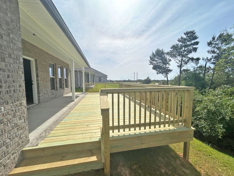 Front exterior of a new home in The Bluffs at Lafayette, Freeport, FL, highlighting curb appeal (Image 17).