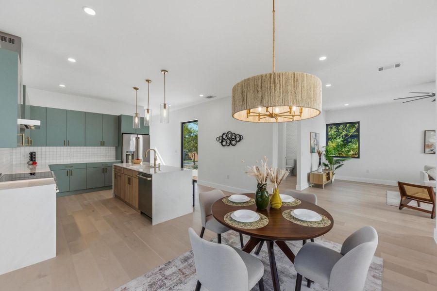 Dining area with light wood finished floors, plenty of natural light, and recessed lighting