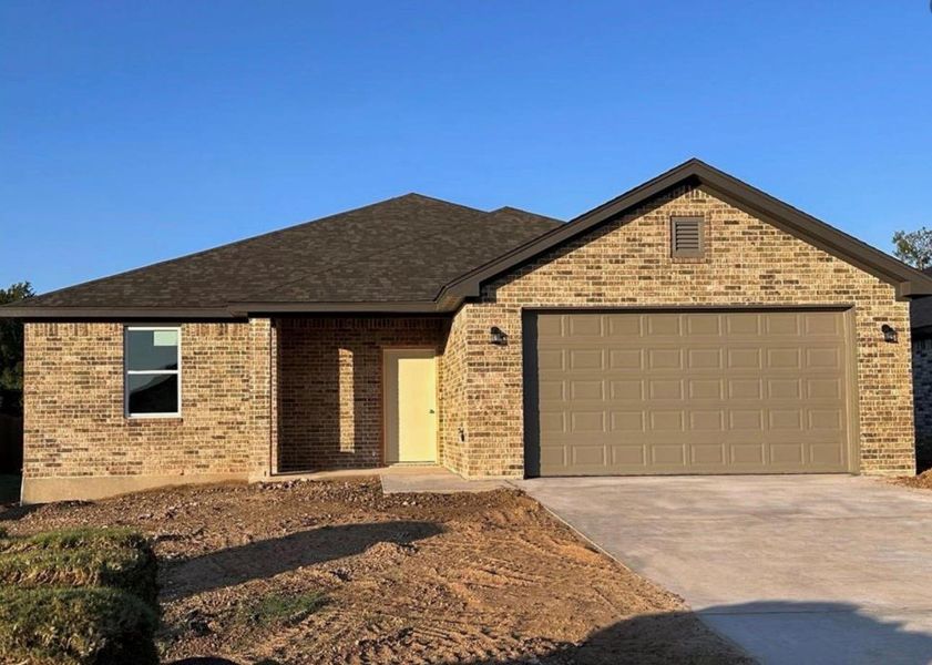 View of front of home featuring driveway, brick siding, a garage, and a shingled roof View of front of home featuring driveway, brick siding, a garage, and a shingled roof