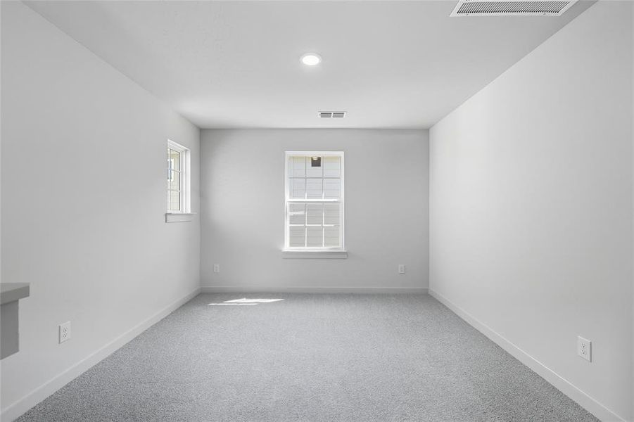 Carpeted empty room featuring baseboards Carpeted empty room featuring baseboards