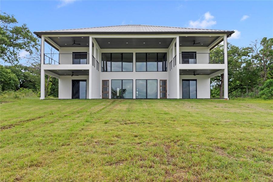 Waterside View of Home showing all four private outdoor spaces plus the main patio off the living space.