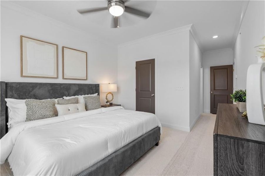 Spacious Primary Bedroom with Ceiling Fan and Walk In Closet *Images shown are from a decorated model of the same floor plan. Design selections and color packages will vary by home.*